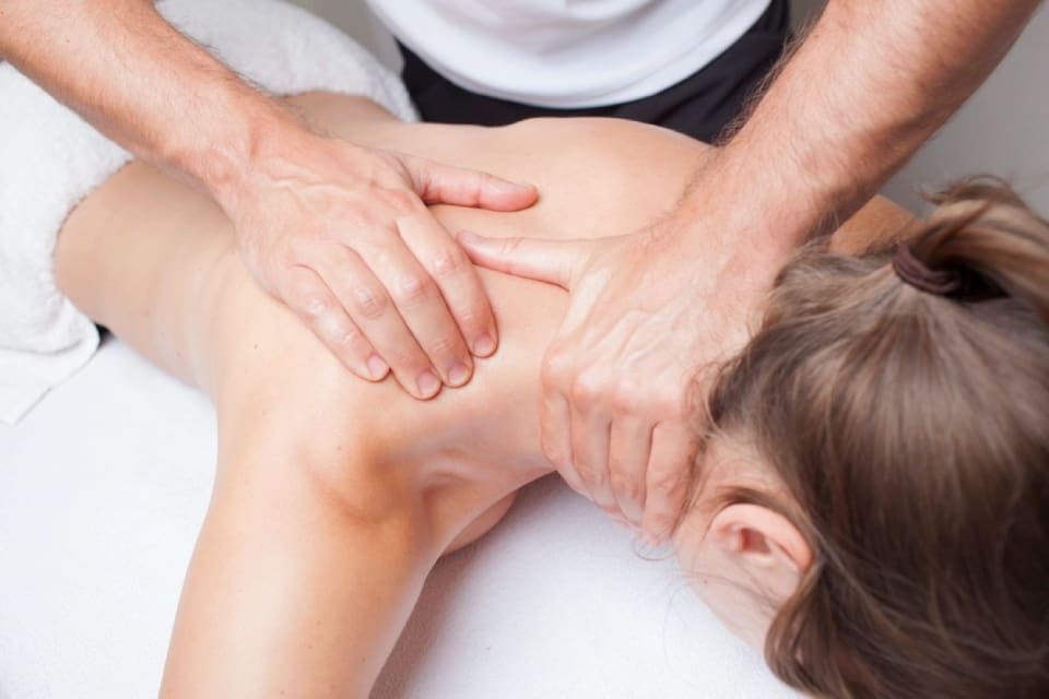 A person getting their back massage done by someone else