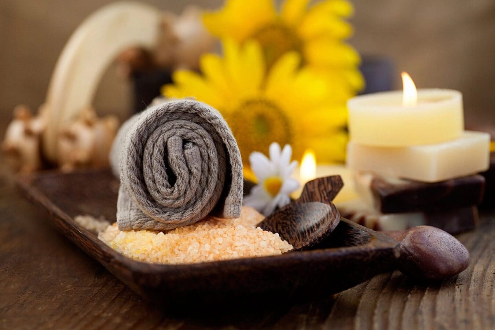 A towel and some chocolate on top of a wooden tray.